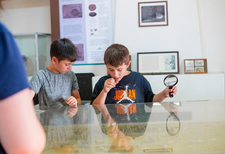 Kids exploring with a magnifying glass